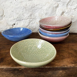 A grouping of small porcelain Brewery Pottery bowls handmade from slabs of clay textured with vintage lace. When in the kitchen, we love and use these little catch all ceramics bowls for salsas, dips, hummus, ice cream, small snacks, and even those tiny leftovers.