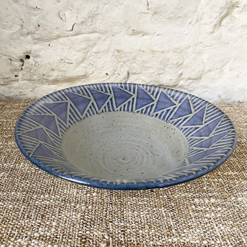 Thrown Brewery Pottery bowl with a blue hand carved  pattern. Using a handmade bowl is a great way to enjoy and enhance your favorite meals. Whether you're eating alone or serving a friends, using handmade ceramic bowl is a lovely way to showcase your beautifully prepared meal.